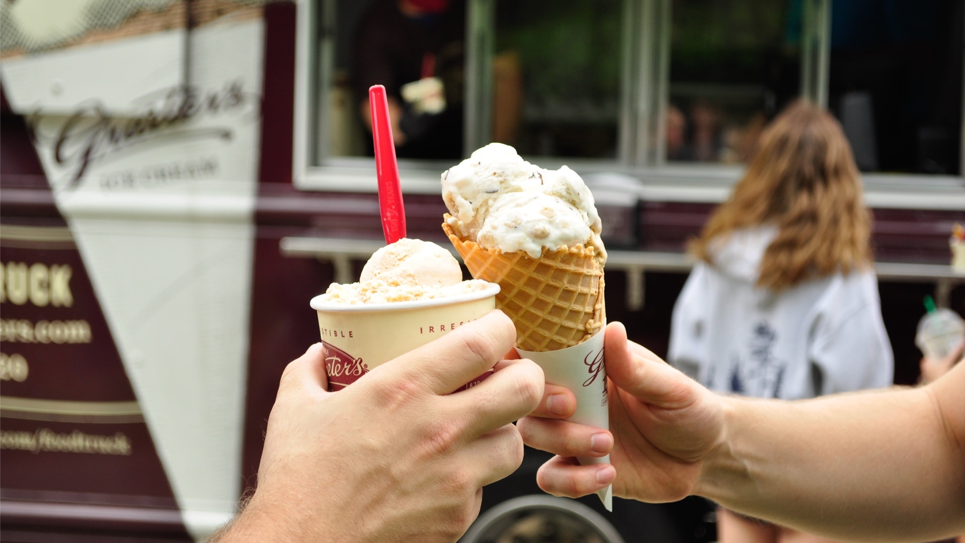 A cup of Grater's Vanilla Ice cream and a cone of Grater's Chocolate chip Cookie Dough Ice Cream.