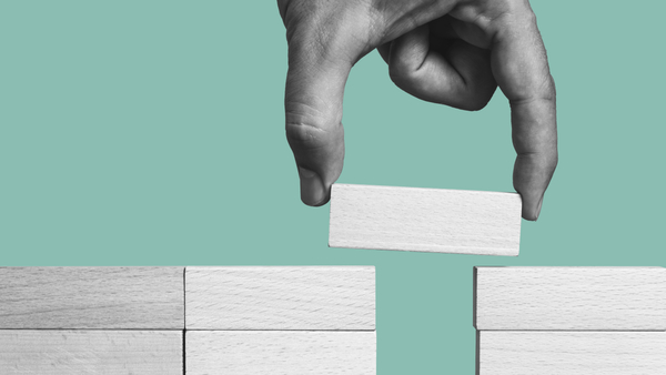 hand placing a block