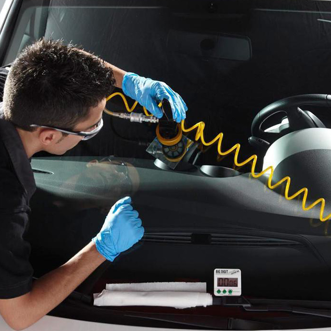 A Belron® mechanic working on a customer's vehicle.